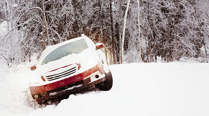 A car stuck in a snowy ditch