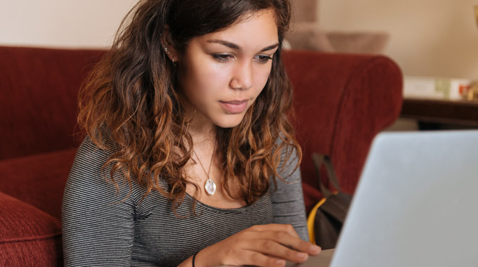 Teenager works on a laptop