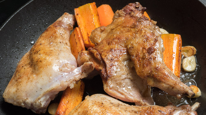 A plate of roasted rabbit and carrots