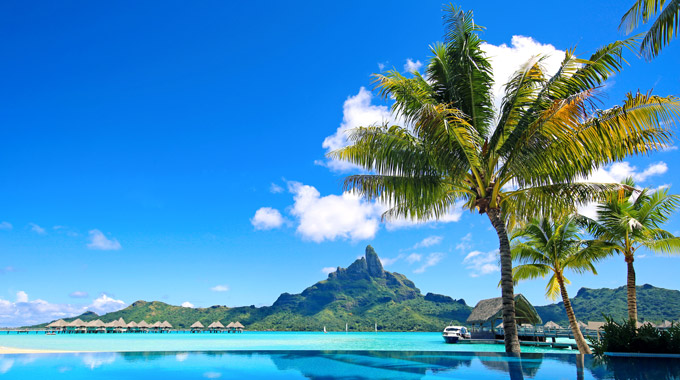 A view of palm trees and Mount Otemanu on Bora Bora.