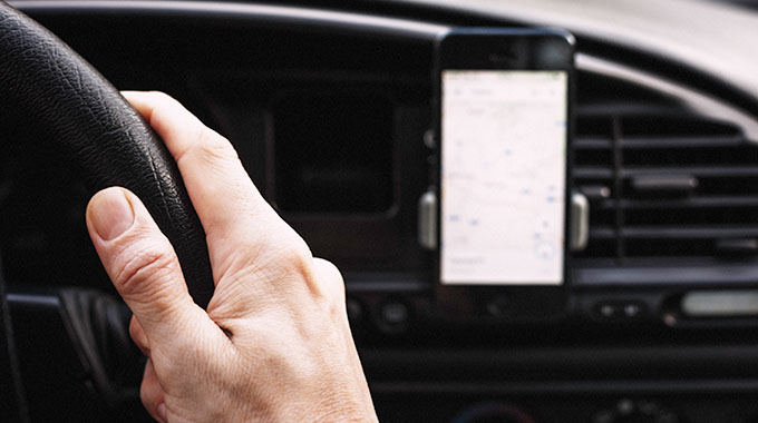 A smartphone mounted to a car's AC vent