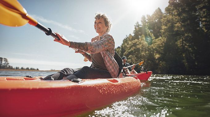 A woman kayaks on a sunny day