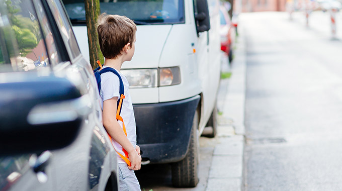 A young boy looking before crossing the street