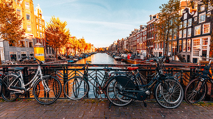 Bicycles on a bridge over a canal in Amsterdam in autumn.