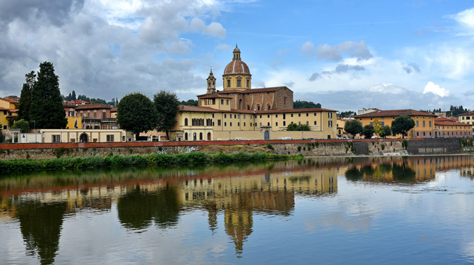 The Basilica di Santo Spirito reflected in the Arno River 