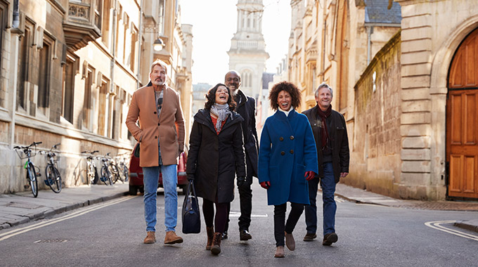 A group of travelers walking together in a historic old town