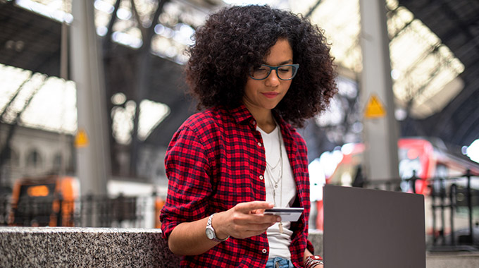 Woman uses her laptop at a train station