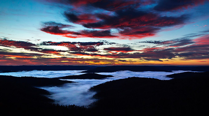 A sunrise above Buffalo National River with clouds lit red