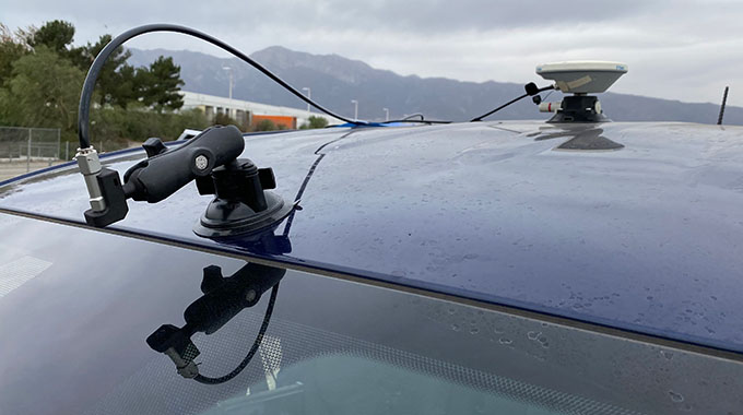 A car windshield fitted with a water spraying nozzle for safety testing