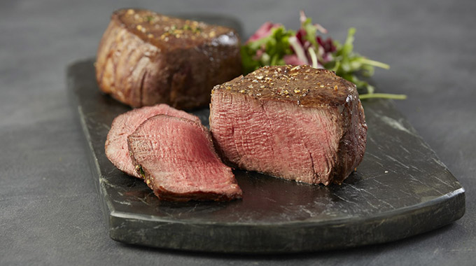 A cooked steak, cut and served, from Chicago Steak Company