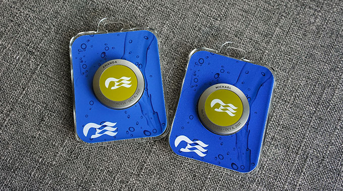 A pair of Princess Cruises' OceanMedallion devices in lanyard cases