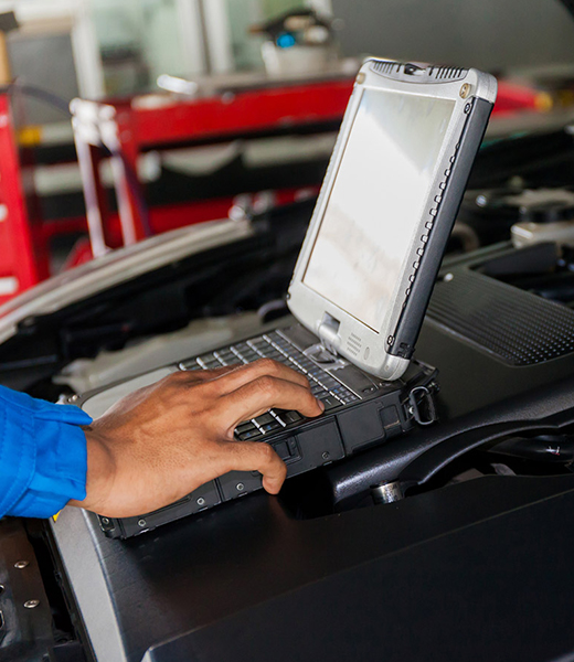 Mechanic looking at car diagnostics on a machine