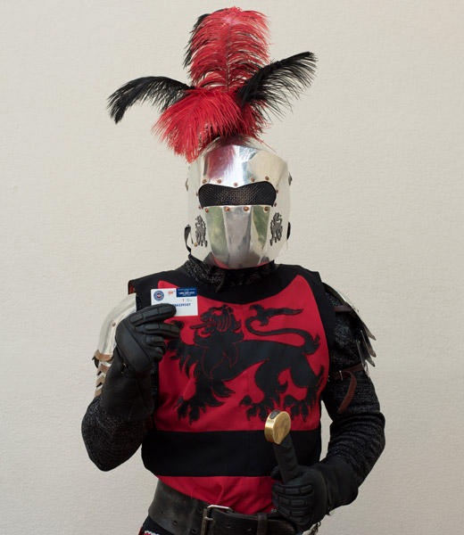 Medieval Times knight holds his AAA membership card