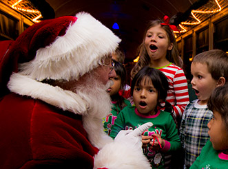 Santa Claus talking to kids aboard the Grand Canyon Railway Polar Express Christmas train