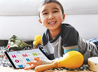 A young boy using HOMER Learning on a tablet