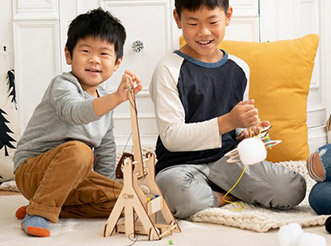 Two boys playing with KiwiCo learning kits