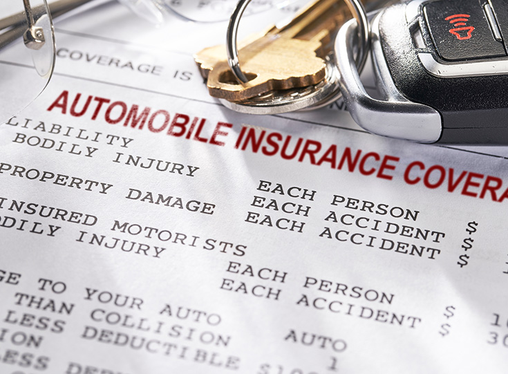 Car keys on automobile insurance document Car keys on automobile insurance document