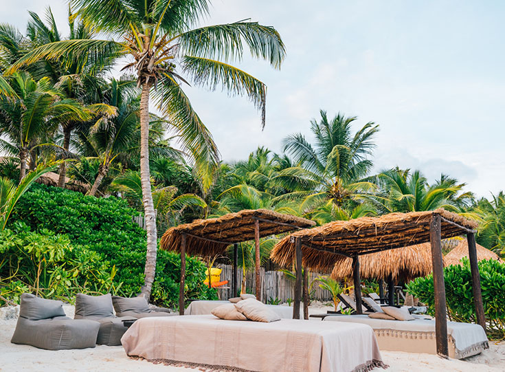Massage tables on the beach at a resort in Tulum, Mexico
