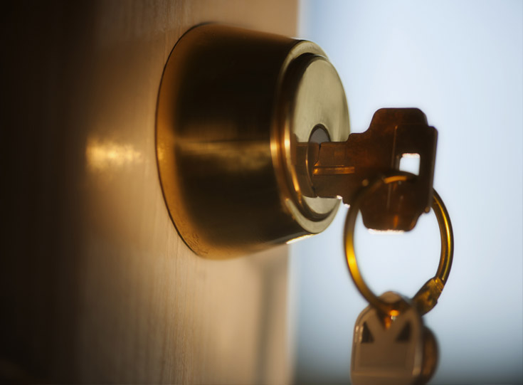 Close up of a key inside a door deadbolt lock Close up of a key inside a door deadbolt lock