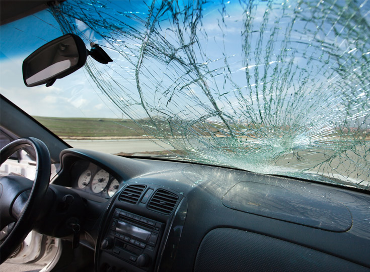 View of a broken windshield from inside the vehicle View of a broken windshield from inside the vehicle