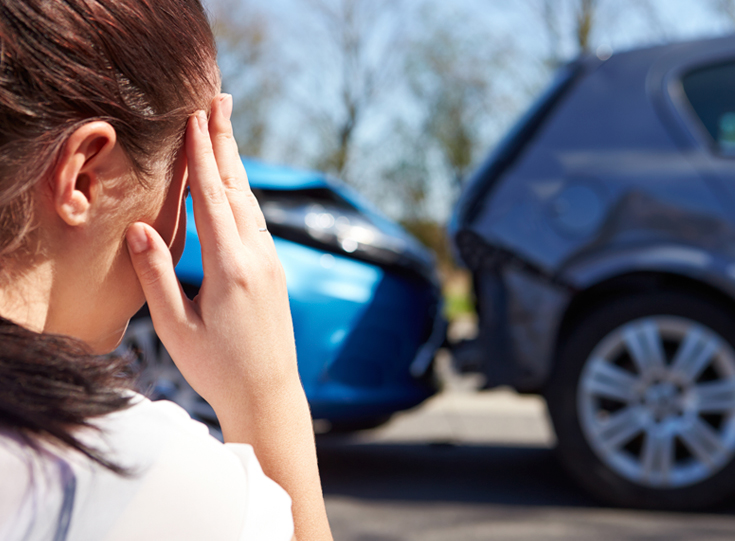Woman looking at crashed cars Woman looking at crashed cars