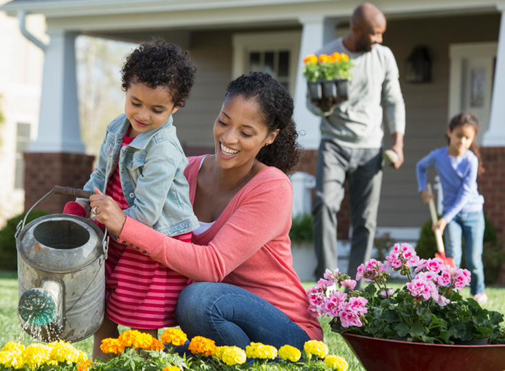 Family planting flowers in from of home Family planting flowers in from of home