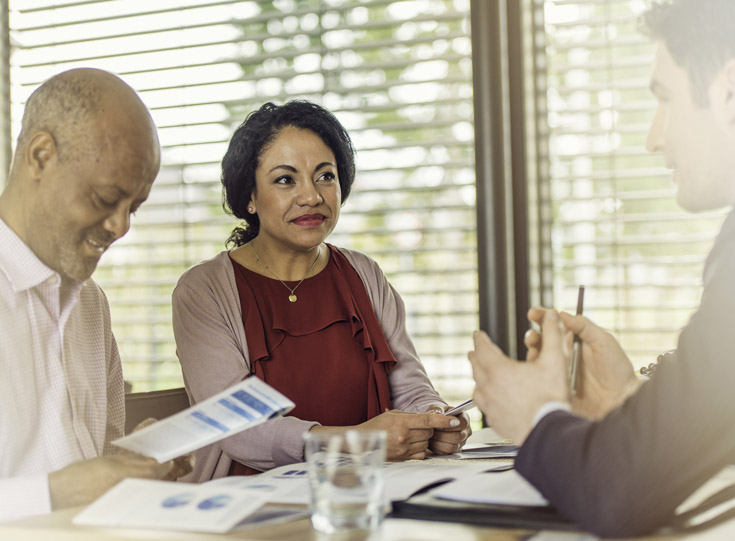 Couple talking to a claims rep about the auto claims process Couple talking to a claims rep about the auto claims process