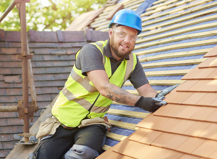 Man fixing roof of home Man fixing roof of home