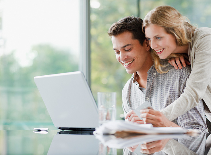 A couple reviewing online car insurance quotes on a laptop A couple reviewing online car insurance quotes on a laptop