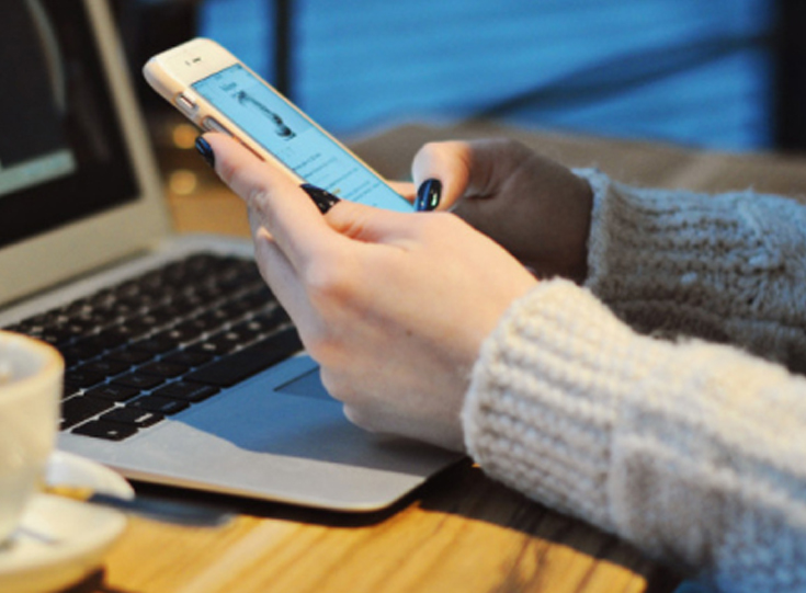 A woman's hands holding a cell phone A woman's hands holding a cell phone