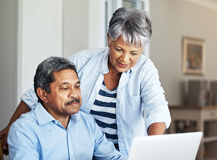 Couple looking at laptop screen Couple looking at laptop screen