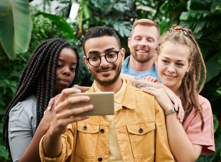 A group of people taking a selfie A group of people taking a selfie