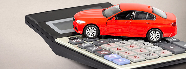 Red toy car on calculator Red toy car on calculator