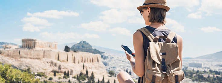 Woman holding smartphone while traveling Woman holding smartphone while traveling