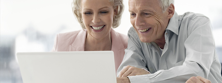 Mature couple looking at laptop Mature couple looking at laptop