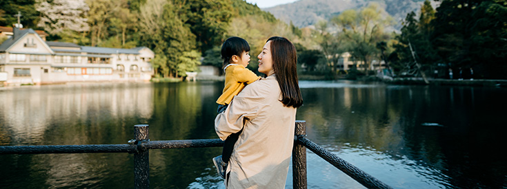 Mom holding daughter at lake Mom holding daughter at lake