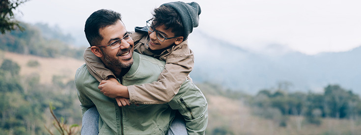 Father giving son a piggy back ride Father giving son a piggy back ride