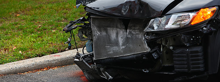 View of a broken windshield and deployed airbag from inside the vehicle View of a broken windshield and deployed airbag from inside the vehicle