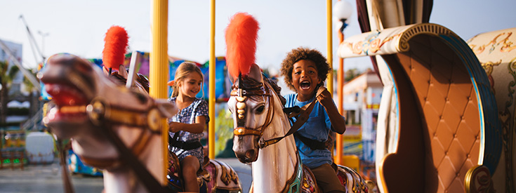 Kids on theme park carousel Kids on theme park carousel