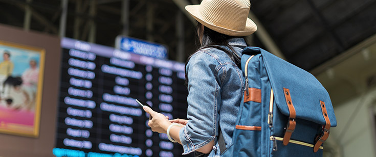 Woman at airport looking at departure information Woman at airport looking at departure information