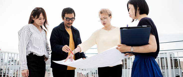 Group of 4 people reviews a business plan Group of 4 people reviews a business plan
