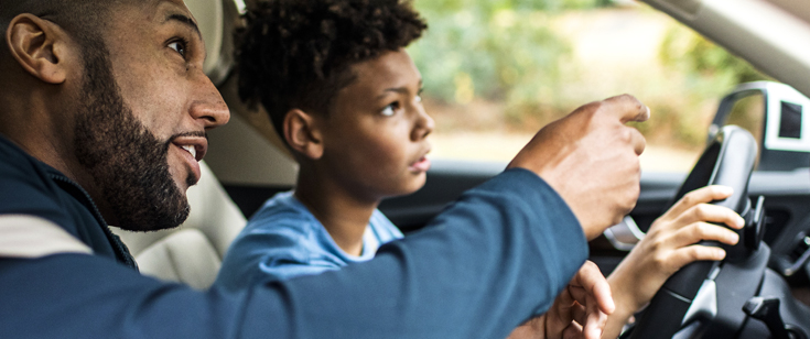 Father giving teen son a driving lesson Father giving teen son a driving lesson