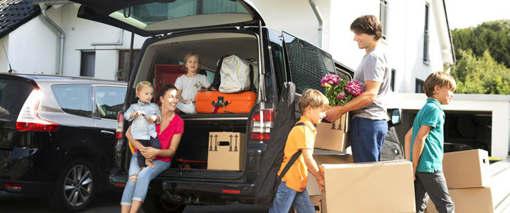 Family of 6 unloading boxes from fully packed vehicle Family of 6 unloading boxes from fully packed vehicle