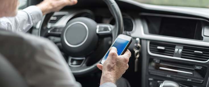 Man texting while driving Man texting while driving