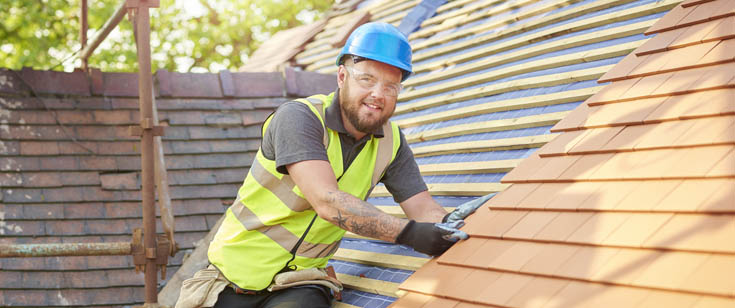 Construction worker on the roof of a home Construction worker on the roof of a home