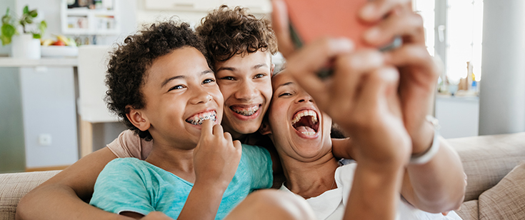 Family taking selfie on couch Family taking selfie on couch