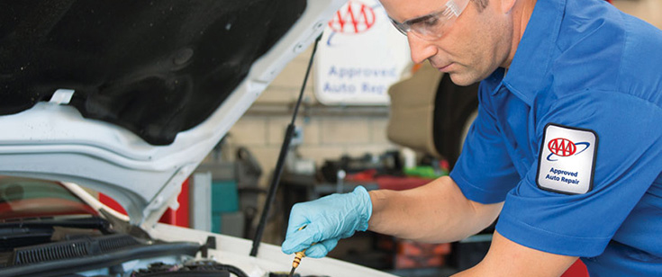 AAA mechanic looking a car engine AAA mechanic looking a car engine
