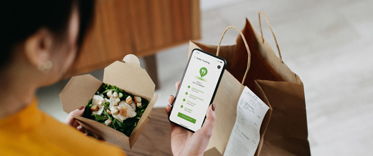 Woman using app on her cell phone to order food Woman using app on her cell phone to order food