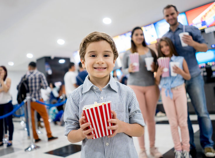 Young boy holding popcorn Young boy holding popcorn