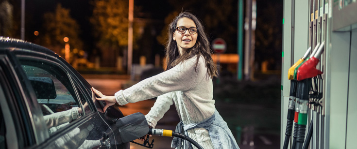 Woman pumping gas